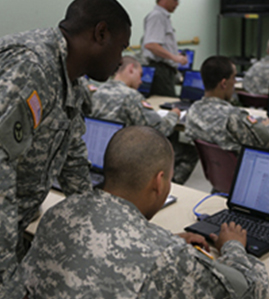 Service members at computer. 
