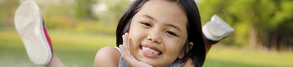 Smiling girl laying in the grass