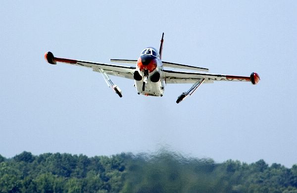 A T-2C Buckeye, assigned to the U.S. Naval Test Pilot School, folds-up its landing gear as it takes off for a training flight from Naval Air Station Patuxent River, Md. 