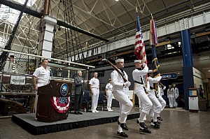 The official party stands at attention during the parading of the colors during the centennial celebration for the office of the Chief of Naval Operations and Navy staff at the Washington Navy Yard.