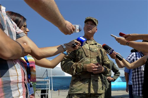 California Army National Guard Maj. Gen. Matthew Beevers answers reporters' questions during the Romanian air force's 71st Air Base's air show and open house at Campia Turzii, Romania, July 23, 2016. 