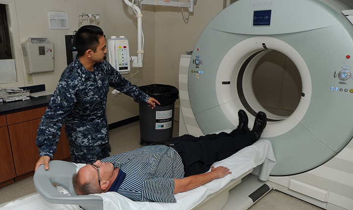 A patient at Naval Hospital Pensacola prepares to have a low-dose computed tomography test done to screen for lung cancer. Lung cancer is the leading cause of cancer-related deaths among men and women. Early detection can lower the risk of dying from this disease. (U.S. Navy photo by Jason Bortz)