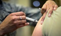 U.S. Air Force Staff Sgt. Bianca Raleigh, 31st Medical Operations Squadron, allergy and immunizations, administers a patient's shot, at Aviano Air Base, Italy. (U.S. Air Force photo by Senior Airman Areca T. Wilson)