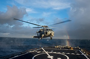 An MH-60S Sea Hawk helicopter assigned to the Dragon Whales of Helicopter Sea Combat Squadron (HSC) 28 lands on the flight deck aboard the guided-missile destroyer USS Donald Cook (DDG 75).