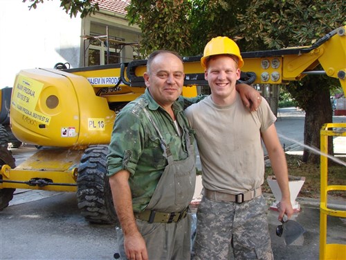 LAPOVO, Serbia &mdash; Spc. Eric D. Mackey and his Serbian army civilian counterpart Milosevic Miroslay share stories of the day&#39;s work at Svetozar Markovic elementary school in Lapovo, Serbia, where they are completing renovations together through the National Guard Bureau State Partnership Program. Ohio and Serbia have been partnered since 2006. (Department of Defense photo by 1st Lt. Nicole Ashcroft)