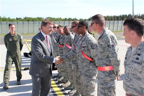 Estonian Prime Minister Andrus Ansip shakes hands with Airmen from the Michigan Air National Guard at Amari Air Base, Estonia, June 15, 2012. The Airmen were at Amari for Saber Strike 2012, a multi-national exercise based in Estonia and Latvia. Lt. Col. William Henderson is behind the prime minister. 