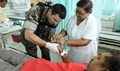 An MHS health care provider engages and tends to a patient in need of treatment. (Photo by PO1 William Parker)