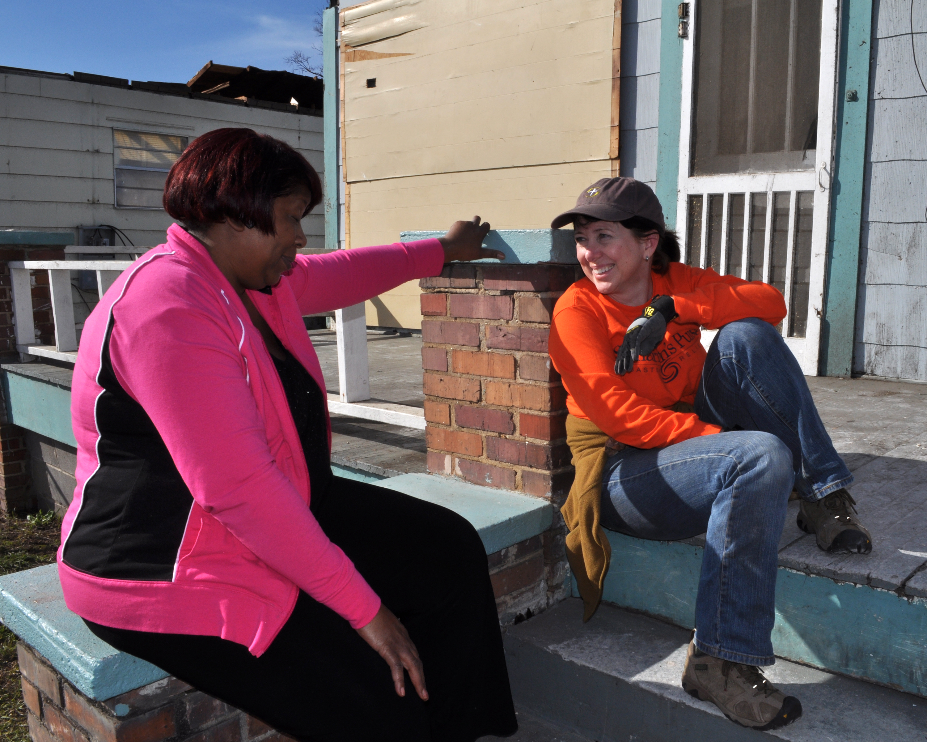 A Samaritan's Purse volunteer sits down for a moment with homeowner Ollie Harris. Volunteers are an essential workforce in the recovery effort, working tirelessly gutting homes so they can be restored. Photo by Marilee Caliendo/FEMA 