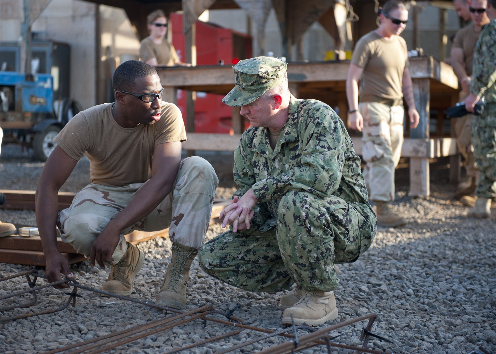 CAMP LEMONNIER, Djibouti (Dec. 9, 2011) - U.S. Navy Petty Officer 3rd Class Tykeus Pettway, Naval Mobile Construction Battalion 5 steelworker, shows Master Chief Petty Officer of the Navy Rick D. West an example of the work the Seabees perform at Camp Lemonnier, Djibouti, December 9. During his visit, West toured Camp Lemonnier and met with leadership and Sailors to discuss current issues affecting them. (U.S. Navy photo by Petty Officer 2nd Class Jeremy S. Brandt)