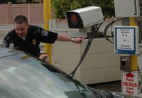 CBP Officer Adam Roberts directing a traveler on how to use the RFID technology at the Peace Bridge border crossing in the Port of Buffalo, NY at 7 a.m. today Photo:CBP