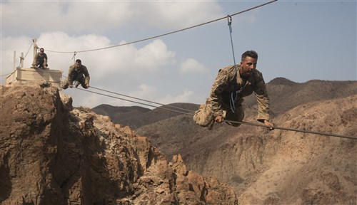 ARTA PLAGE, Djibouti – U.S. Army Soldiers from the 1st Battalion, 124th Infantry Regiment, assigned to Combined Joint Task Force-Horn of Africa, make their way across a portion of the mountain obstacle course, as part of the final day of the French Marines Desert Survival Course, Oct. 10, 2016, at Arta Plage, Djibouti. Approximately 46 U.S. Army Soldiers with French Marines completed several tasks during the survival course, including desert operations, combat lifesaving skills, weapons training, survival cooking, how to decontaminate water, and water and mountain obstacle courses. (U.S. Air Force photo by Staff Sgt. Tiffany DeNault)