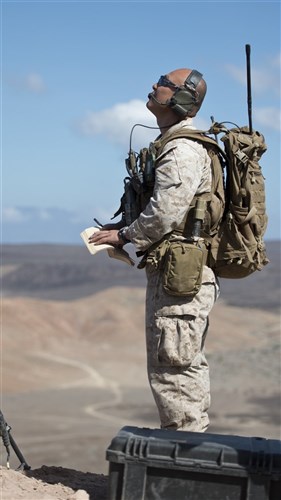 U.S. Marine Corps Staff Sgt. Adam Haley, 24th Marine Expeditionary Unit joint terminal attack controller, observes a French Air Force Rafale M multi-role fighter aircraft flyby in during a training exercise in Arta, Djibouti, Feb. 4, 2015. The aircraft was part of a scheduled bilateral training exercise to prepare U.S. and French militaries for future joint operations. (U.S. Air Force photo by Staff Sgt. Kevin Iinuma)