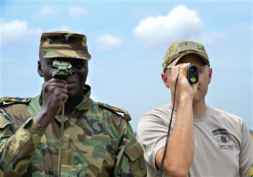 Sr. Air Force Master Sgt. Benjamin Barnett (right), 435th Contingency Response Group contingency airfield manager, and Ghana army Captain Seth Essiaw, establish a drop zone using a military lensatic compass and range finder Sept. 14,2016, during African Partnership Flight in Accra, Ghana. APF workshops are designed to provide diverse experiences to many air professionals at one time. (U.S. Air Force photo by Staff Sgt. Stephanie Longoria/Released)