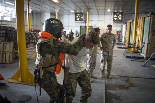 A member of the Angolan marines escorts Lance Cpl. Micah Salmon during a training exercise aboard the Military Sealift Command’s joint high-speed vessel USNS Spearhead (JHSV 1) as part of Africa Partnership Station March 6, 2015. Spearhead is on a scheduled deployment to the U.S. 6th Fleet area of operations to support the international collaborative capacity-building program Africa Partnership Station. (U.S. Navy photo by Mass Communication Specialist 2nd Class Kenan O’Connor/Released)