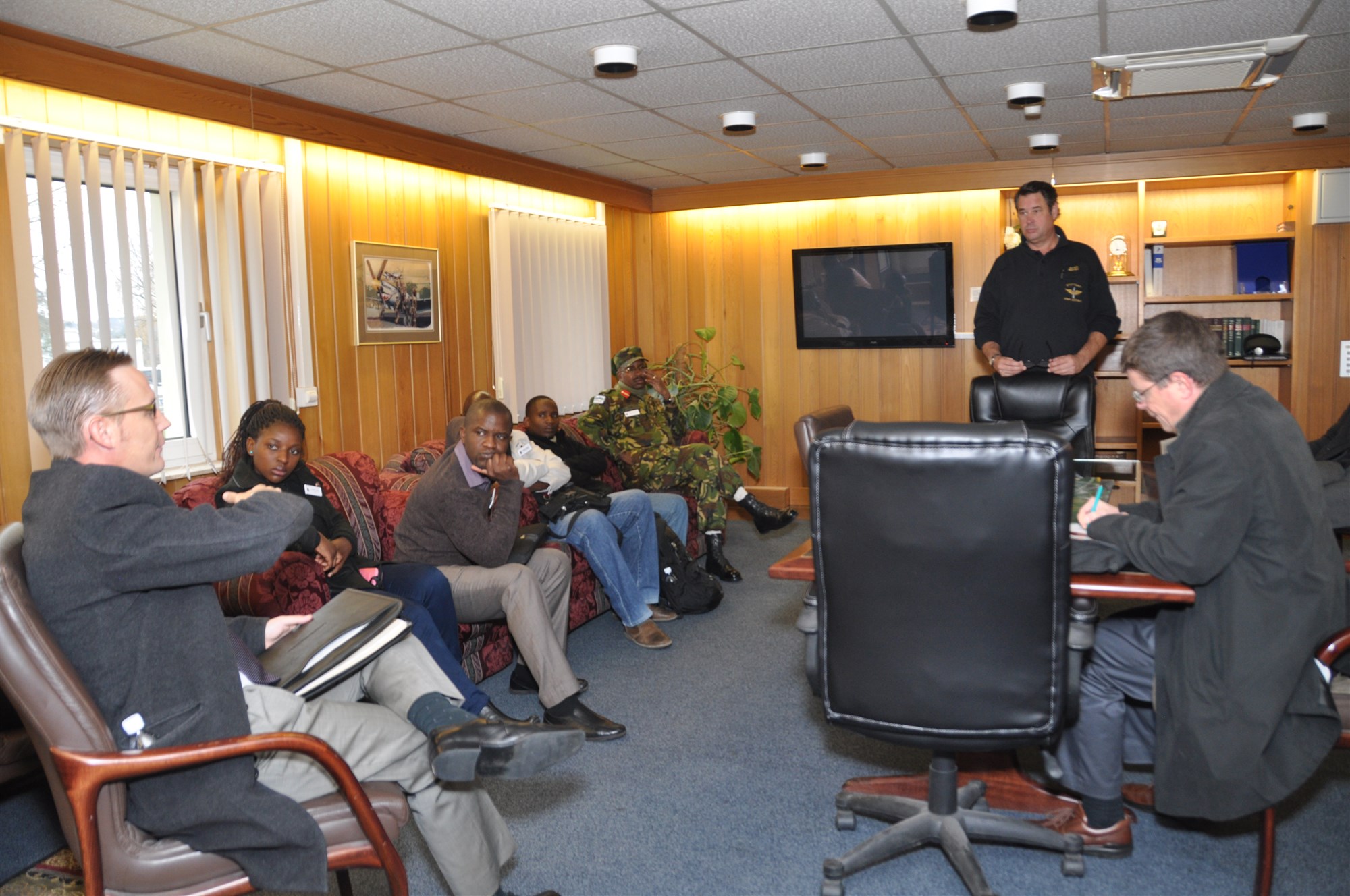 During a visit to the Stuttgart Army Air Field, Nov. 19, 2014, journalists from Malawi and Botswana get a briefing on SAAF operations before getting a tour of the parking ramp. The journalists, along with a military public affairs officer from each country, were invited by AFRICOM Public Affairs and selected by U.S. embassy staff to participate in a program designed to enhance journalists' understanding of the command's mission and programs on the continent.