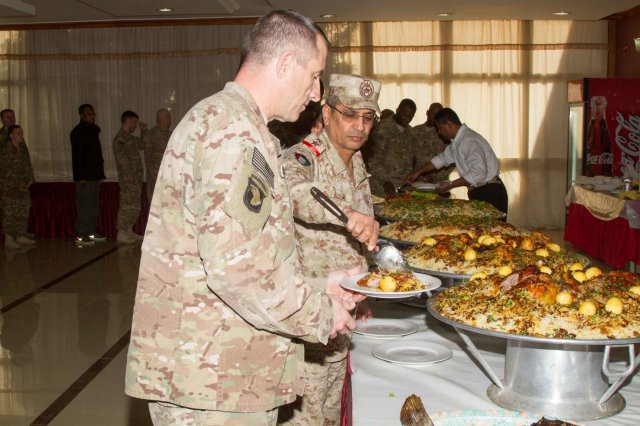 Col. Mohammad D. al Khranij, the commander of the Kuwaiti army's 35th Armored Brigade, serves food to Maj. Gen. William Hickman,S. Army Central's deputy commanding general-operations, during the leader professional development seminar at the headquarters for 35th Armored Brigade. The day's events focused on the role the 35th Armored Brigade played at the Battle of the Bridges, a large battle at the beginning of Saddam Hussein's invasion of Kuwait 25 years ago. 
