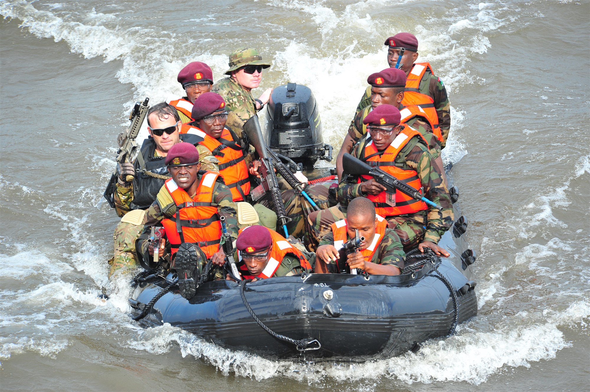 U.S. Special Operations Forces, along with Malawi Defense Force (MDF) Paratroopers, perform a beach landing during rehearsals for an assault upon a compound during a simulated crisis at the Fish Eagle Inn, in Salima, Malawi, May 6, 2013. The main exercise was preceded by pre-exercise training between US SOF and MDF, which included skills such as marksmanship, small unit tactics, close quarters battle, combat medicine, and mission planning. (U.S. Air Force photo by Master Sgt. Larry W. Carpenter Jr.)