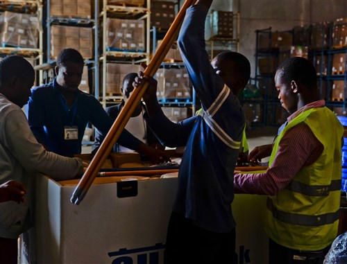 Workers at the main supply warehouse, prepare a resupply box for one of the Ebola treatment units, Monrovia, Liberia, Nov. 26, 2014. The World Food Program will be transitioning to take over supply operations mid-December. Through the combined effort with their U.S. Service member partnership, they've established an efficient process for distributing much needed supplies to ETUs throughout the area. Operation United Assistance is a Department of Defense operation in Liberia to provide logistics, training and engineering support to U.S. Agency for International Development-led efforts to contain the Ebola virus outbreak in western Africa. (U.S. Army photo by Sgt. Matt Britton 27th Public Affairs Detachment/RELEASED)