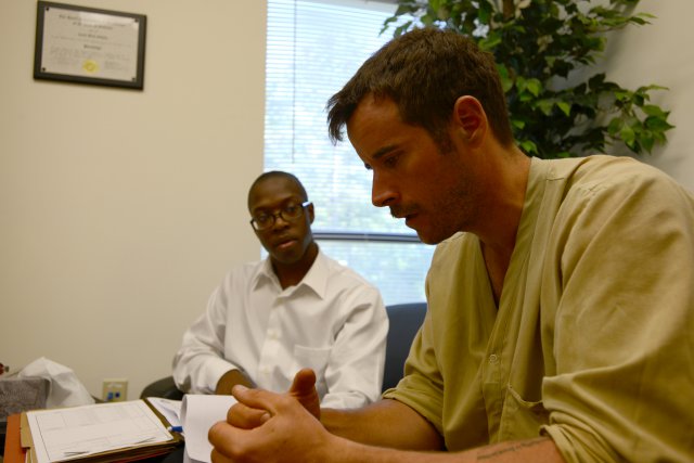 Warrant Officer Joshua Bone (right), a recent Survival, Evasion, Resistance and Escape school graduate, tries to recal details of his captivity as Spc. Keith Lewis (left), a de-briefer assigned to the 470th Military Intelligence Battalion, listens Sept. 18 at Fort Rucker, Alabama. Bone was one of five SERE students who volunteered to participate in a post-isolation reintegration exercise hosted by U.S. Army South Sept. 15-21.