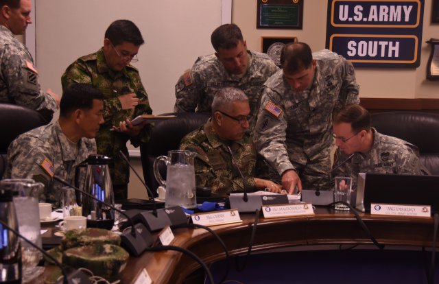Lt. Col. Doug Judice, Army mission chief for the U.S. Security Cooperation Office in Colombia, explains the specifics of the bilateral engagement plan to Maj. Gen. Joseph P. DiSalvo, U.S. Army South commanding general, and Maj. Gen. Ernesto Maldonado Guarnizo, deputy commander for Colombian army, during the U.S.-Colombia Bilateral Army Staff Talks Executive Meeting, April 28 - May 1, 2015. The talks were hosted by Army South headquarters.