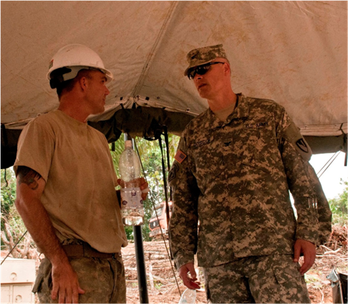 Naples, Fla., native Staff Sgt.  Christopher LaMay, left, speaks with Col. Heath Roscoe, commander for the 36th Engineer Brigade from Fort Hood, Texas. Roscoe spoke with members of the 104th Company, 62nd Battalion in Gbediah, Liberia on Dec. 5, 2014. The 104th Company just arrived at Gbediah and will spend three weeks there building an Ebola treatment unit. Operation United Assistance is a Department of Defense operation in Liberia to provide logistics, training and engineering support to U.S. Agency for International Development-led efforts to contain the Ebola virus outbreak in western Africa. (U.S. Army photo by Capt. Eric Hudson, Joint Forces Command – United Assistance Public Affairs/RELEASED)
