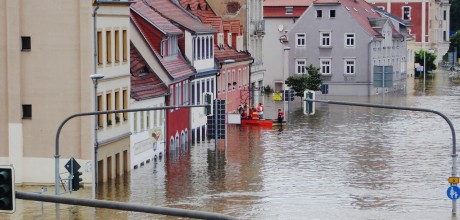 Flooded street with buildings and rescue boats