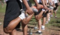 Nearly 90 Naval Reserve Officers Training Corps freshman midshipman candidates stretch their legs during their introduction to unit physical training at Camp Navajo, Arizona, during joint New Student Orientation.