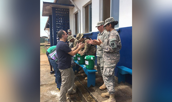 Army Capt. Jasmin Gregory carefully observes her students as they demonstrate hand-washing techniques during the World Health Organization Ebola clinical training in support of Operation United Assistance in Monrovia, Liberia.