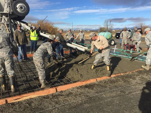 Airmen from the 92nd Civil Engineer Squadron lay the concrete foundation for the new pump house Nov. 2, 2015, at Fairchild Air Force Base, Wash. More than 120 Airmen from the 92nd CES spent the last two years building a new facility, which controls sewer pumps for the Survival, Evasion, Resist and Escape School. (Courtesy photo)