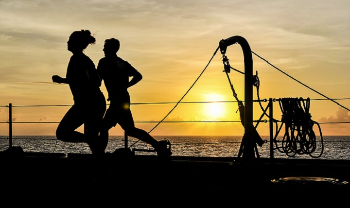 Boatswain's Mate 3rd Class Megumi Gudino (left) and Seaman Brian Holst (right) both attached to the U.S. 7th Fleet flagship, USS Blue Ridge, run on the main deck during sunset. The National Institutes of Health recommends at least 75 minutes of vigorous aerobic exercise per week or 150 minutes per week of moderate-intensity aerobic exercise. (U.S. Navy photo by Mass Communication Specialist Seaman Jordan Kirk Johnson)