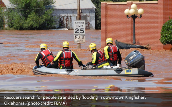 Rescuers search for people stranded by flooding in downtown Kingfisher, OK. Photo courtesy of FEMA