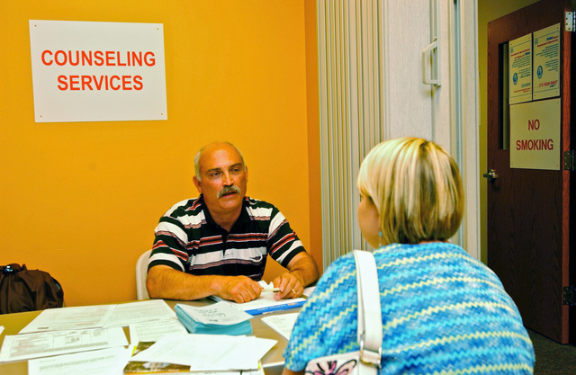 Findlay, Ohio, September 14, 2007 -- John Guagentei (L) with Century Health - a Mental Health organization in Findlay, talks with a woman whose home was damaged from flooding in the community. FEMA arranges for counseling desks at Disaster Recovery Centers (DRC) as part of assisting flood victims.  John Ficara/FEMA