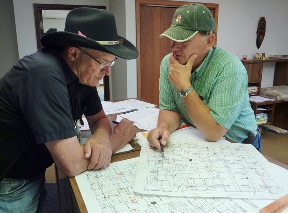 Webster, S.D., July 12, 2011 -- FEMA Public Assistance Coordinator Jim Russell (left) and Day County S.D. Highway Supervisor Chuck Fromelt, look over township maps reviewing damage incurred from recent flooding.