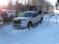 Image of a white truck parked in the snow