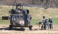 A litter team from Expeditionary Medical Force Great Lakes One performs triage on a casualty delivered by a U.S. Army HH-60 Blackhawk helicopter on Forward Operating Base Liberty during Exercise Northern Lights. 