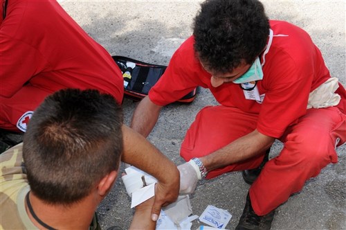 CAMP PEPELISHTE, Macedonia   A Macedonian Red Cross member stabilizes a stick that went through the hand of a victim of an explosion during Medical Training Exercise in Central and Eastern Europe 2011 June 11. Macedonian and U.S. service members were given a variety of moulaged injuries to simulate ones experienced by mudslide, building collapse and explosion victims. The countries participating in this yearrrÃ¢Âs MEDCEUR are Macedonia, Montenegro, Bosnia and Herzegovina, Serbia, Slovenia and Norway. MEDCEUR is a Partnership for Peace and Chairman of the Joint Chiefs of Staff-sponsored regional and multilateral exercise in Central and Eastern Europe designed to provide medical training and operational experience in a deployed environment. (U.S. Air Force photo/Master Sgt. Kelley J. Stewart)