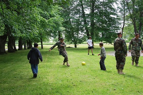 VENTSPILS, Latvia &mdash; After the opening ceremony, children are playing with Seabees from Amphibious Construction Battalion Two with the footballs and basketballs the Seabees brought for the orphanage as a gift June 14. (Department of State photo)