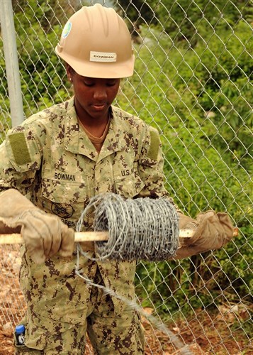 U.S. Navy Seaman Alexandria Bowman, Naval Mobile Construction Battalion 3 from Port Hueneme, Calif., unrolls barbed wire before installing it onto a 2.4 kilometer perimeter fence here May 29. The battalion constructed the fence around the Bosnian-Herzegovinian military compound to meet force protection requirements for the participants of Shared Resilience 2012, a two-week U.S. Joint Chiefs of Staff sponsored medical exercise. NMCB 3 is an expeditionary naval construction element currently assigned to U.S. Naval Forces Europe 6th Fleet's Task Force 68 to provide construction, engineering and security services that support national strategy, naval power projection, humanitarian assistance and contingency operations.