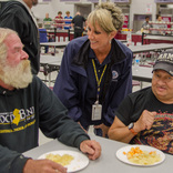 Pleasantville, N.J., Oct. 31, 2012 -- FEMA Community Relations team member Sandy Hendrix talks with survivors Tom Weinstein and Joey Perez at the Red Cross shelter at Pleasantville High School. Photo by Liz Roll/FEMA