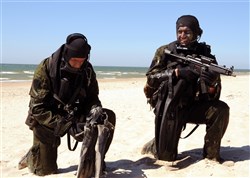 PALANGA, Lithuania – Lithuanian Special Forces combat divers take position on a beach during a Baltic Operations (BALTOPS) 2012 amphibious operation exercise, June 11. This is the 40th iteration of BALTOPS, a maritime exercise intended to improve interoperability with partner nations by conducting realistic training at sea. 