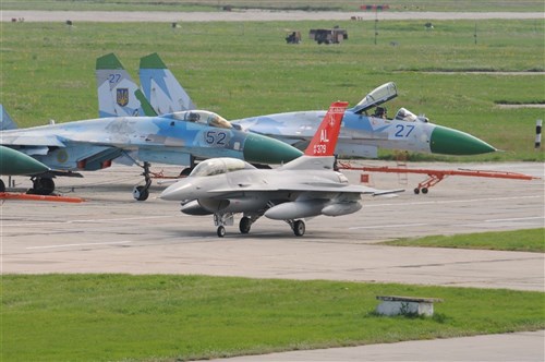 An Alabama F-16C taxis at Mirgorod Air Base, Ukraine, in the background, Ukraine SU-27s sit perched on the ramp ready to begin the training event at SAFE SKIES 2011.  SAFE SKIES 2011 is a joint Ukraine, Poland, U.S. aerial exchange event. (U.S. Air Force Photo by Maj. Matthew T. Mutti, 104FW/CCE, Released).