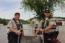 Wardens navigating through a flooded area.