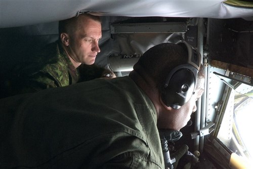 Master Sgt. George Hall, a KC-135 boom operator with the Michigan Air National Guard, prepares to refuel an A-10 Thunderbolt II Aircraft, June 12, 2012 while Lieutenent Col. Janek Lehiste, Air Surveillence Wing Commander with the Estonian Air Force at Amari Air Base observes. Michigan Air National Guard Airmen deployed to Estonia in mid-June 2012 in support of the Saber Strike Exercise, a multinational exercise based in Latvia and Estonia which promotes trust and interoperability among participating nations. 