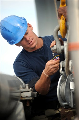 NORTH SEA (July 19, 2011) - Navy Diver 1st Class Steve Vanzant of Mobile Diving and Salvage Unit (MDSU) 2, adjust a shackles pin aboard the Military Sealift Command rescue and salvage ship, USNS Grasp (T-ARS 51). Grasp, MDSU-2 and Navy archeologist, scientist, and historians are currently deployed to the North Sea to conduct diving expeditions. (U.S. Navy Photo by Mass Communication Specialist 1st Class Ja&#39;lon A. Rhinehart/UNRELEASED)