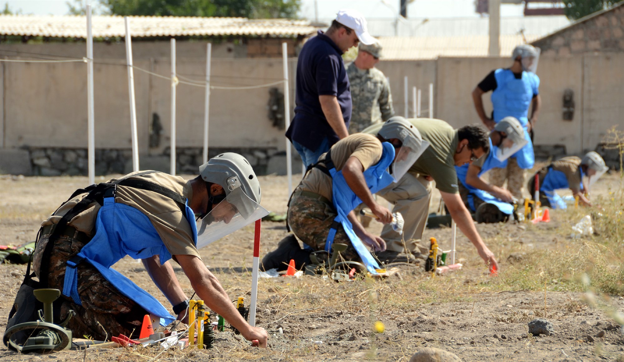 Soldiers from the Engineering Companies of the Armenian Peacekeeping Brigade conduct a simulated one-man demining drill as part of a training course taught by soldiers of the Kansas National Guard and a civilian representative from the U.S. Humanitarian Demining Training Center. Kansas National Guardsmen and the HDTC representative are instructing Armenian peacekeepers and engineer battalions on international demining standards as part of the Humanitarian Mine Action program and will assist the Armenian government in developing a national standard operating procedure for demining.