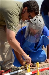 Martin Dumond, training instructor with the U.S. Humanitarian Demining Training Center located at Fort Leonard Wood, Missouri discusses demining with a s soldier from the Engineering Companies of the Armenian Peacekeeping Brigade during a simulated one-man demining drill as part of a training course taught by soldiers of the Kansas National Guard and Dumond. Kansas National Guardsmen and the HDTC representative are instructing Armenian peacekeepers and engineer battalions on international demining standards as part of the Humanitarian Mine Action program and will assist the Armenian government in developing a national standard operating procedure for demining.