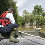 Image cover photo: Search and rescue canvasses Gonzales neighborhood by boat
