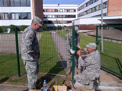 Brig. Gen. Kevin McNeely, deputy of the U.S. European Command Policy, Strategy, Partnering, and Resources Directorate, inspects the newly installed fence at Ādaži High School Aug. 21, 2014, where North Carolina Air National Guard engineers from the 145th Civil Engineer Squadron are finishing the installation project in Ādaži, Latvia.