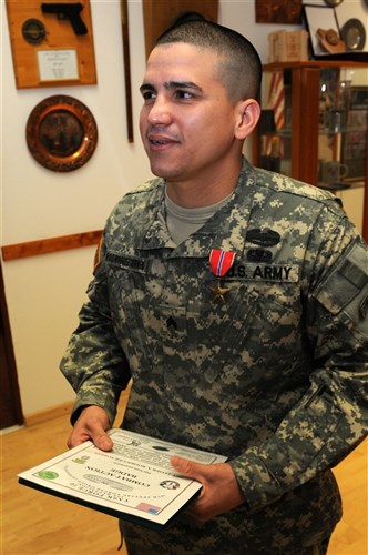 Sgt. Javier Rodriguez-Torres, left, a food service specialist assigned to Headquarters Support Company, 1st Battalion, 10th Special Forces Group (Airborne), proudly smiles following his award ceremony in which he was presented the Bronze Star Medal and the Combat Action Badge for his courageous actions on the battlefield while actively engaging the enemy during his tour in Afghanistan serving with Special Operations Task Unit 0112, Task Force 10. (U.S. Army photo by Master Sgt. Donald Sparks approved for public release by MAJ James Gregory, SOCEUR PAO)