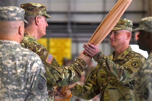 U.S. Army Gen. David M. Rodriguez, U.S. Africa Command commanding general, passes the Combined Joint Task Force-Horn of Africa flag to Brig. Gen. Kurt Sonntag during a change of command ceremony April 13, 2016, at Camp Lemonnier, Djibouti. The passing of the flag signified the change of command from Maj. Gen. Mark Stammer to Sonntag, as the CJTF-HOA commanding general. (U.S. Air Force photo by Staff Sgt. Kate Thornton/Released)